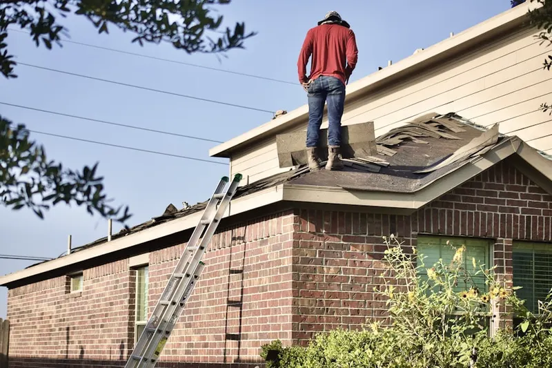 Professional roofer working on a residential roof in North Bay Village